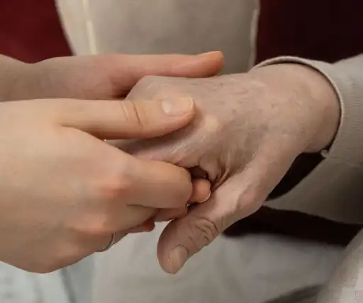 senior hand being held